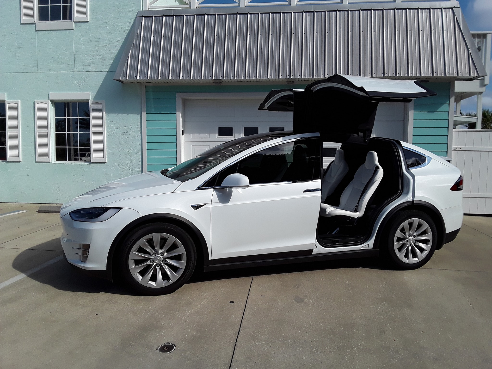 Ceramic tint on a white electric SUV with gullwing doors
